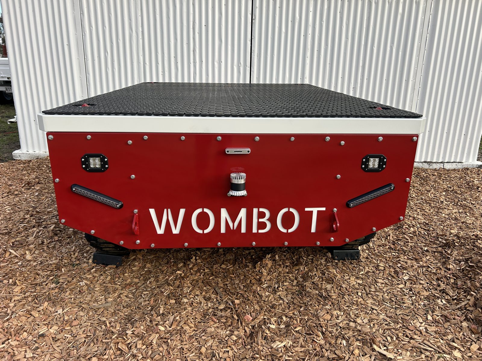 Front view of the Wombot prototype showing the WOMBOT branding and tyre stance