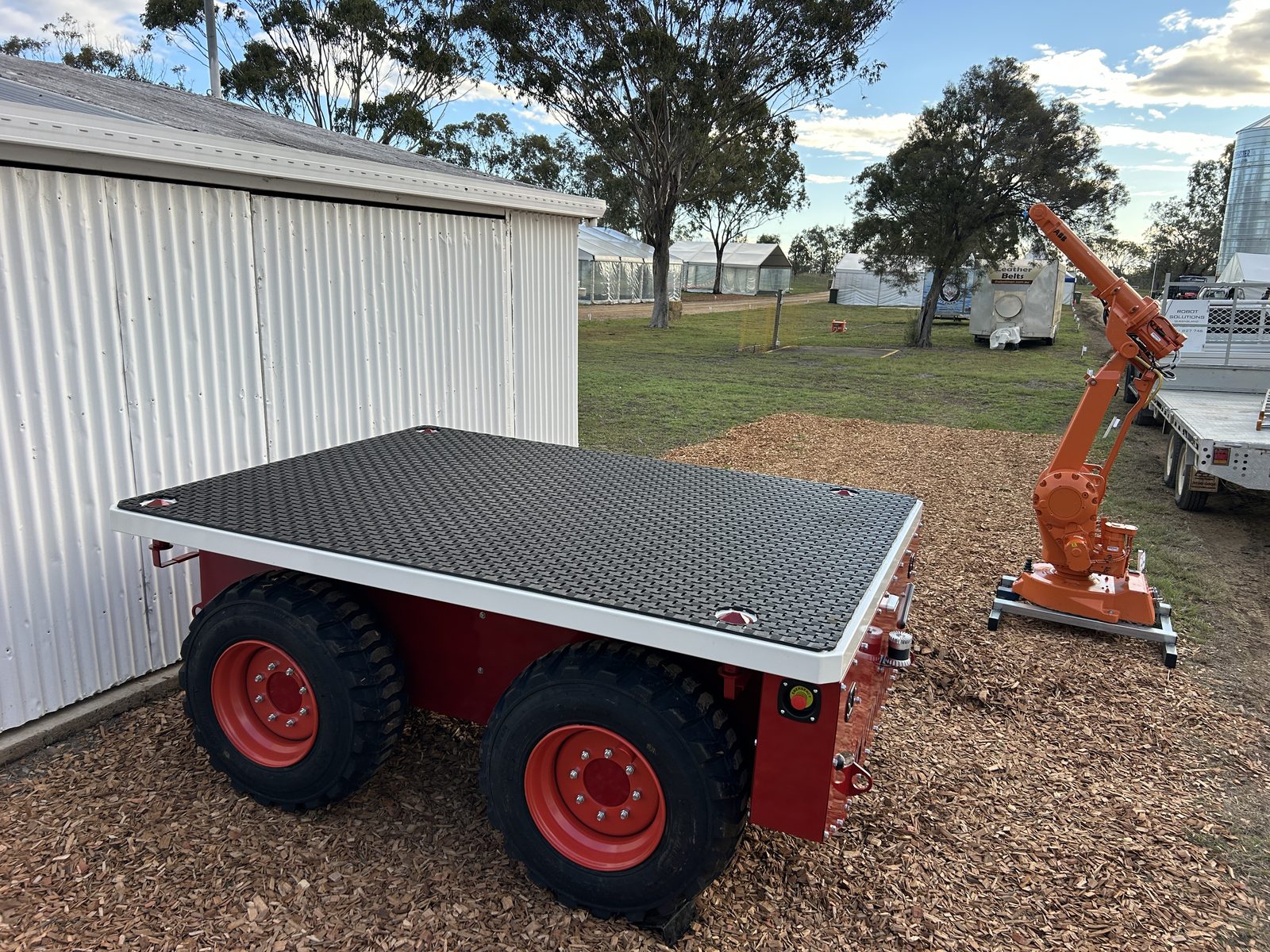 Wombot prototype photographed beside workshop equipment in an operational setting